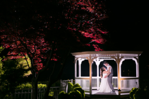 Newlyweds under gabezo at night at Crystal Point Yacht Club NJ Wedding Photographers - Allie and John's Wedding at Crystal Point Yacht Club