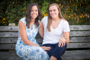 Smiling couple sit together engagement session