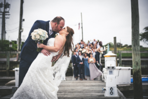 Groom dips bride for a kiss at Crystal Point Yacht Club NJ Wedding Photographer - Shannon and Tim's Wedding