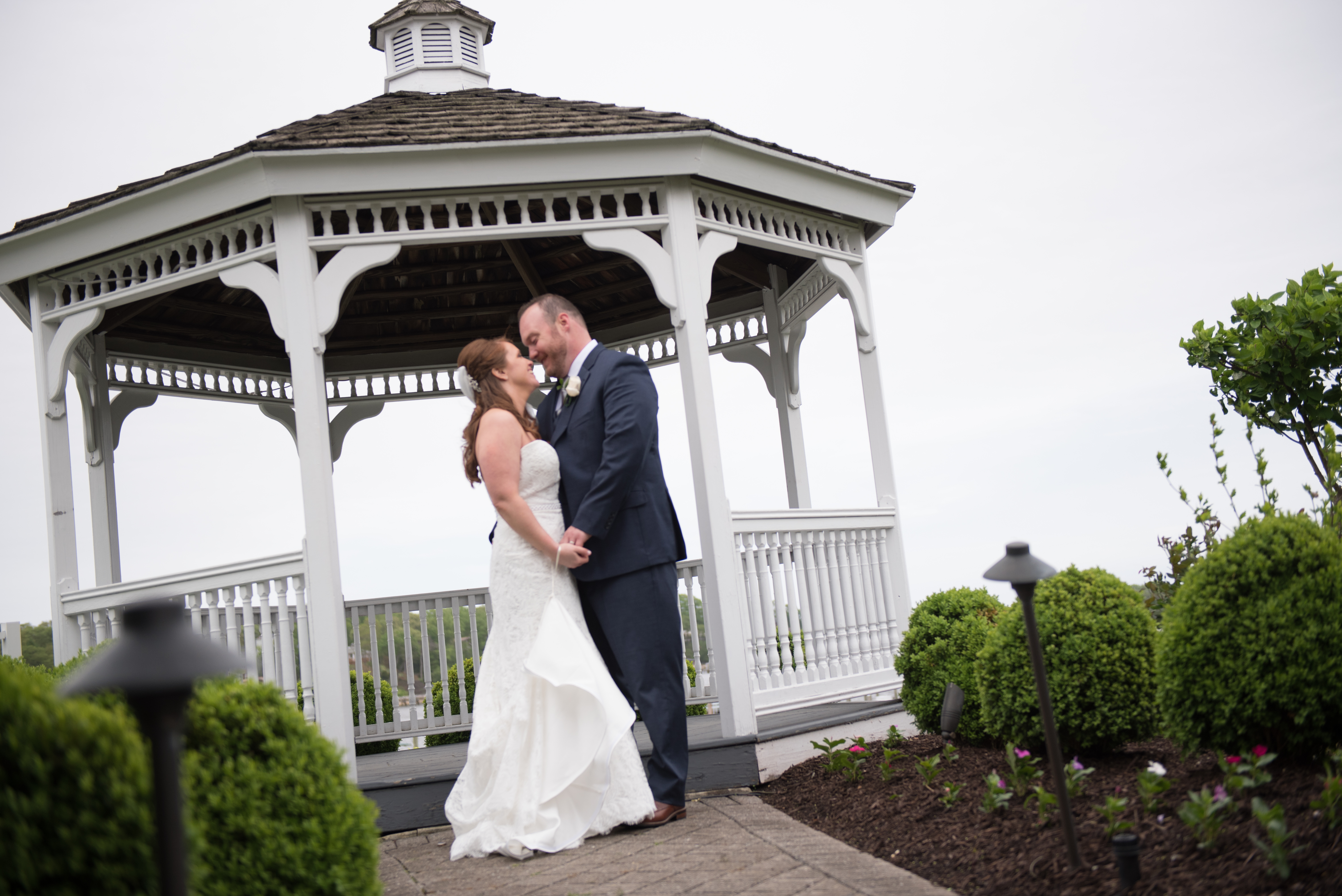 Newlyweds standing and holding hand at Crystal Point Yacht Club wedding