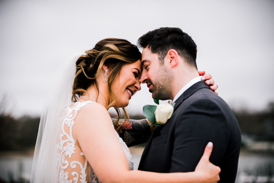 Smiling bride and groom holding each other in Crystal Point Yacht Club wedding video