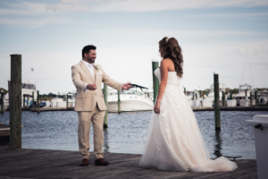 Groom smiling at bride during first look