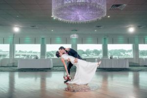 Newlywes kissing under chandelier at Crystal Point Yacht Club wedding