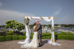 Newlyweds kissing at Crystal Point Yacht Club