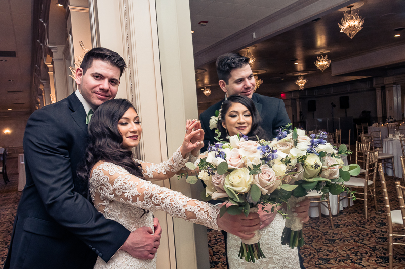 Bride holding flower with groom at Il Tulupano