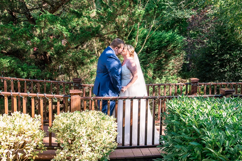 A Romantic Moment on the Wooden Bridge at The English Manor in Ocean wedding photos
