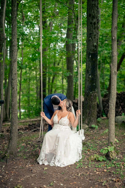 Newlyweds swinging Rock Island Lake Club wedding photos