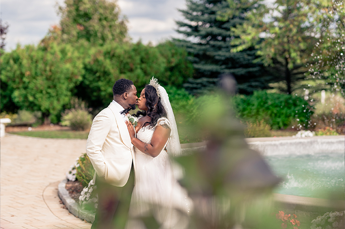 Newlyweds kissing in the garden Aria Banquets CT Wedding Photos and Videos